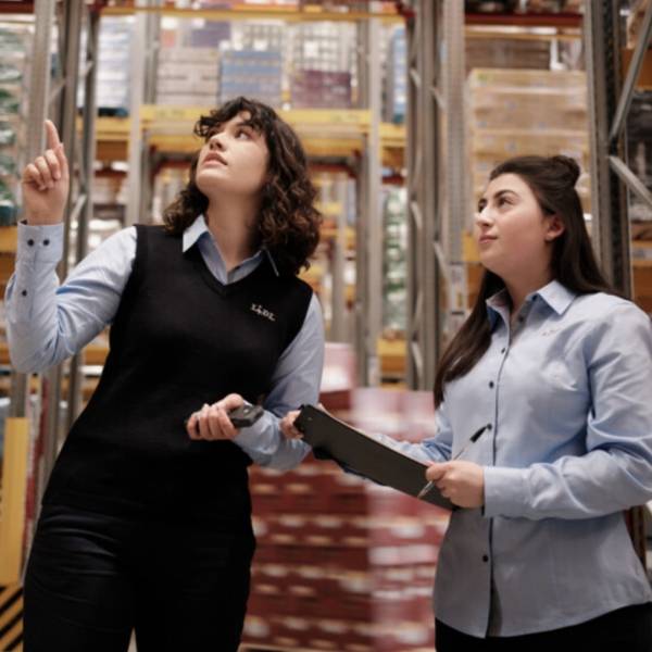 Teamleiterin mit Studentin im Logistiklager
